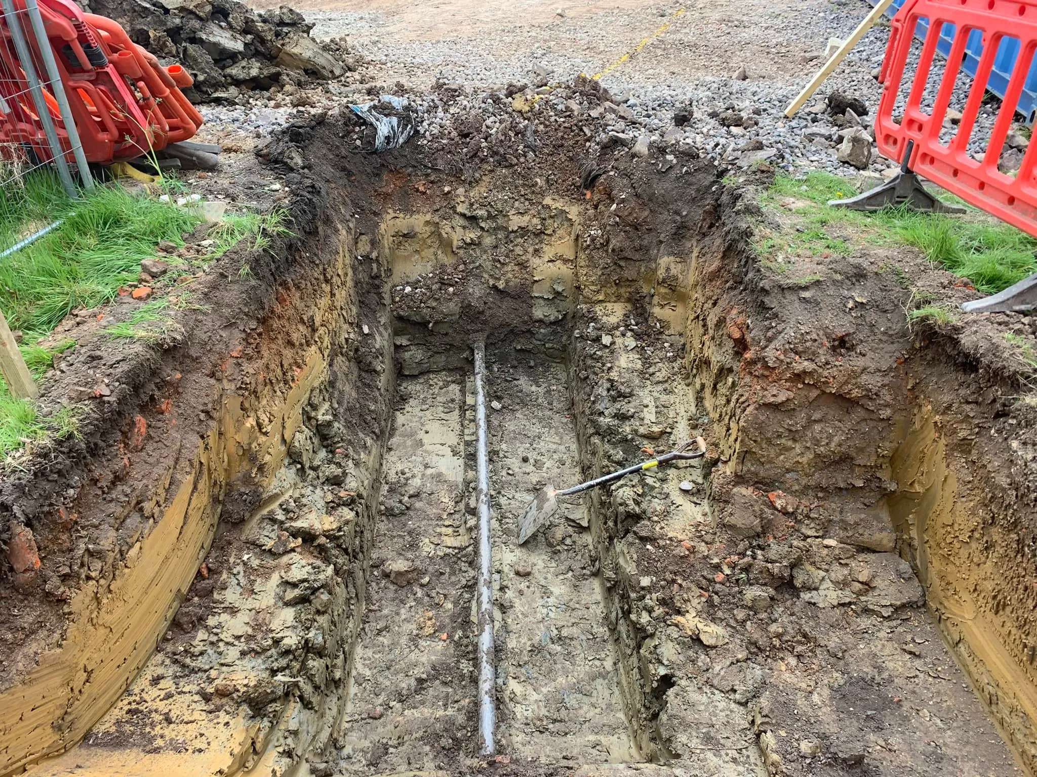 a trench dug in the middle of a dirt field