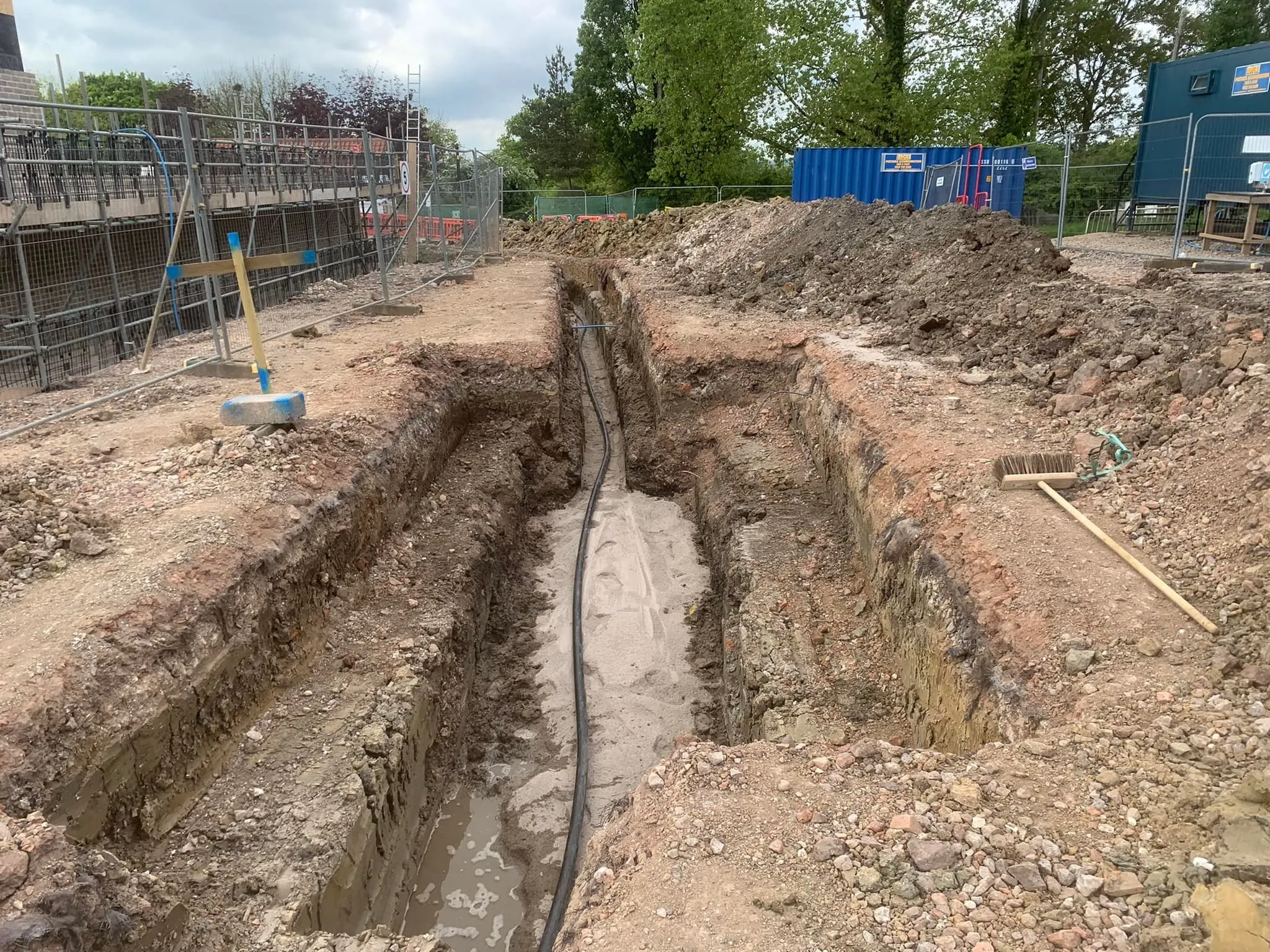 a construction site with a pipe laying in the middle of it