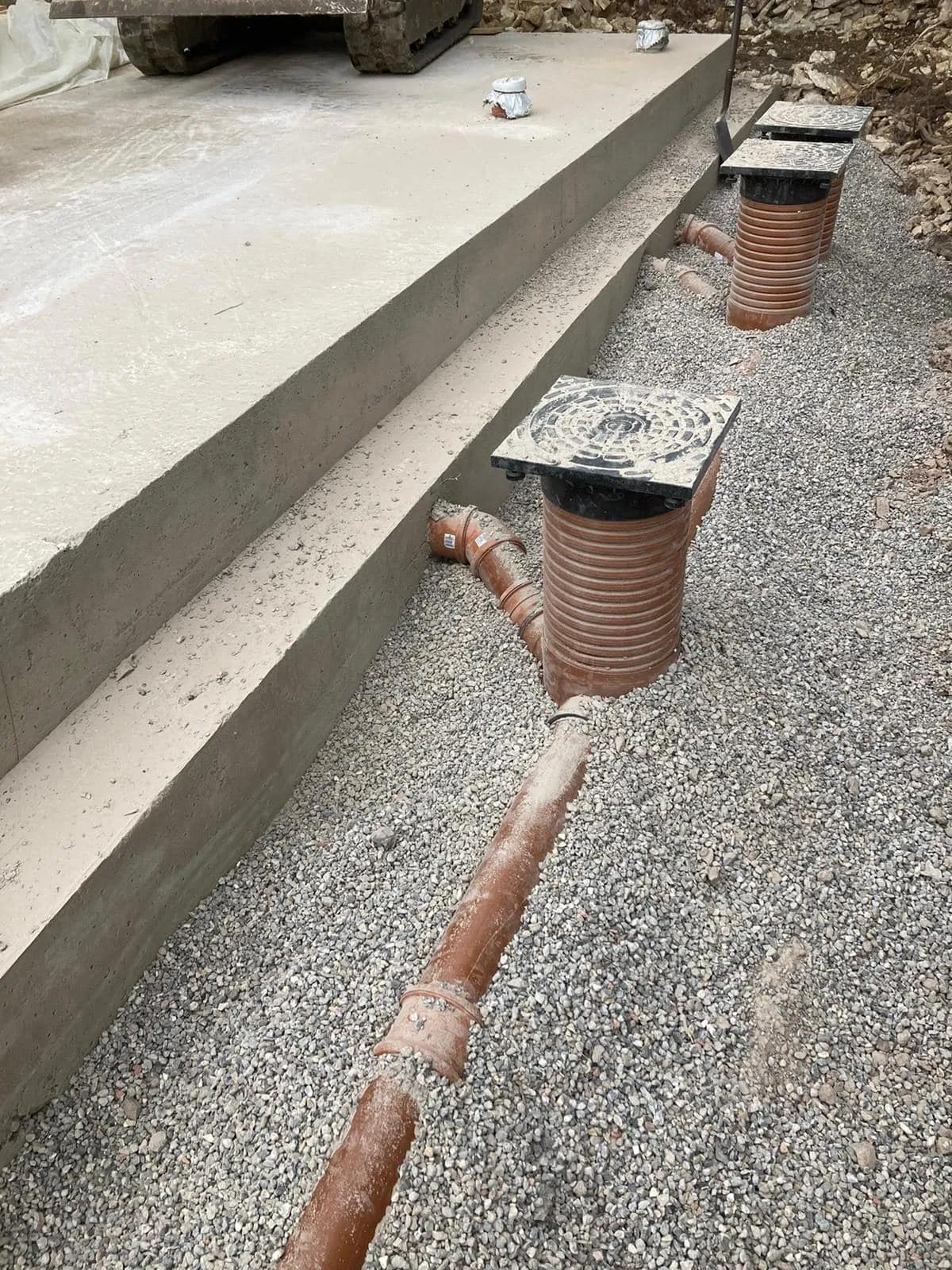 a couple of pipes that are on some concrete