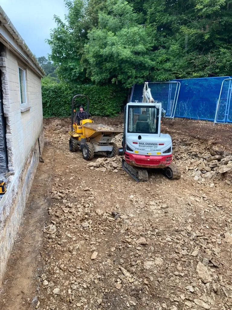 a small tractor parked next to a building