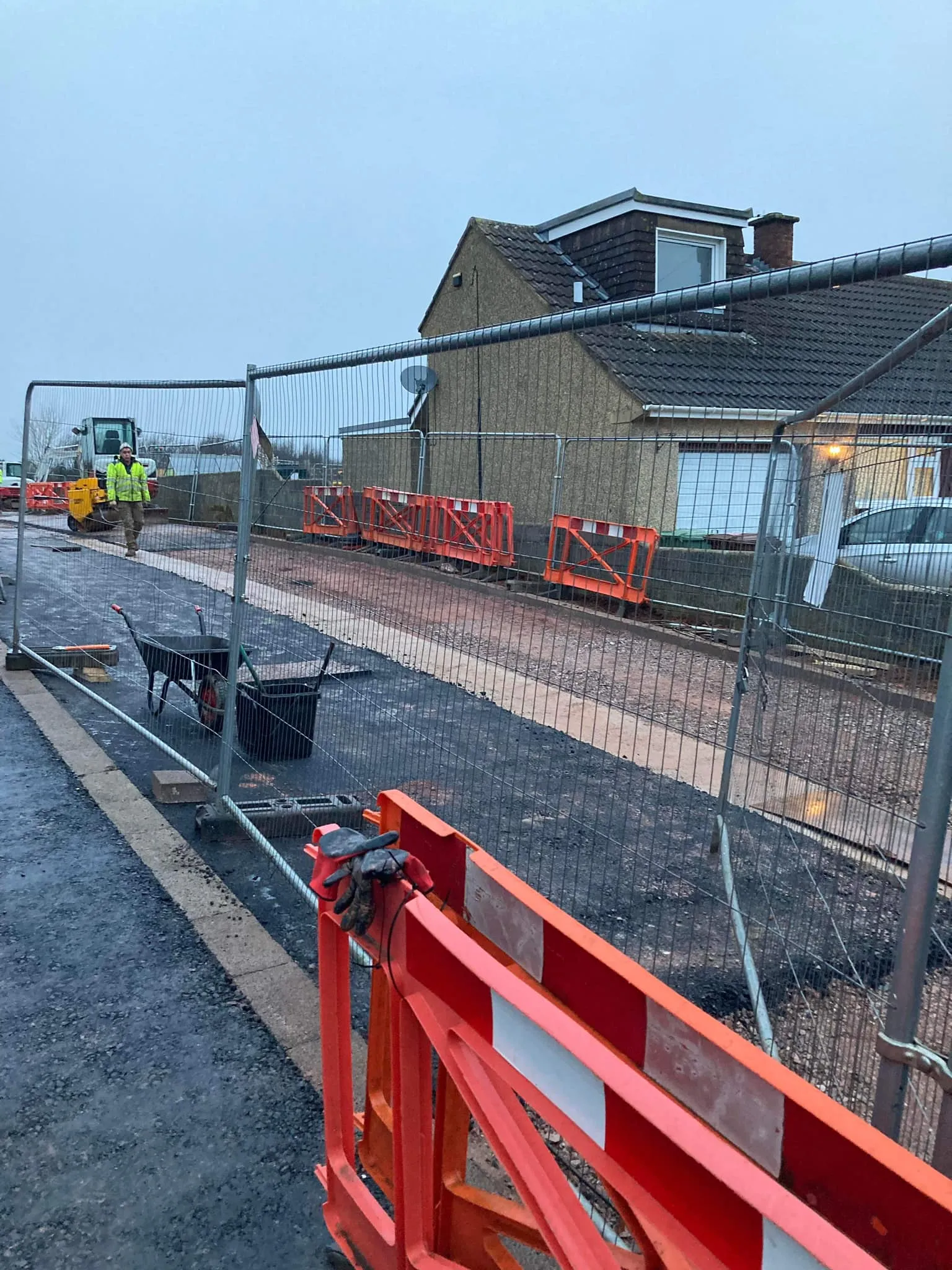 a construction area with a fence and construction equipment
