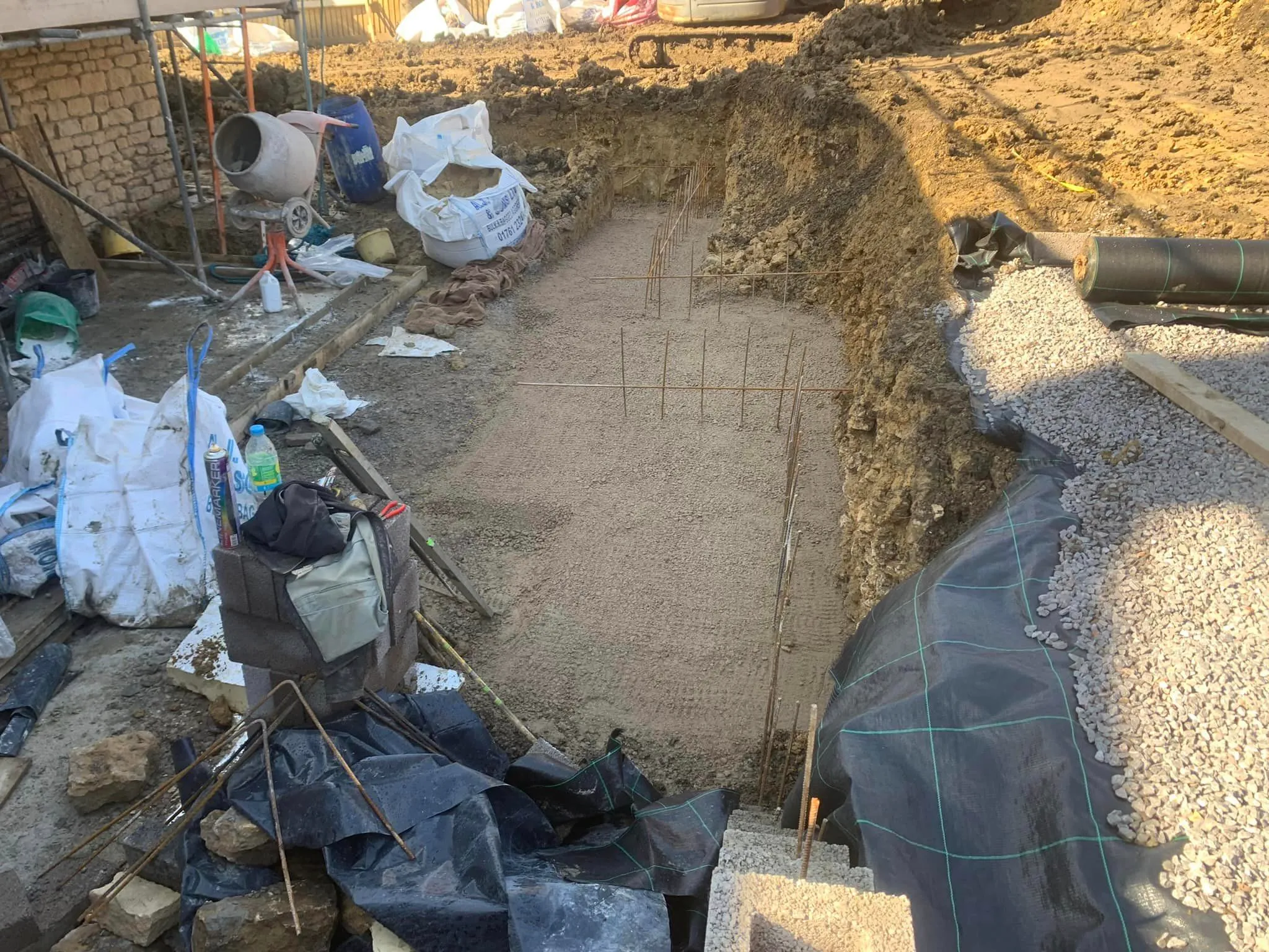 a pile of dirt next to a building under construction